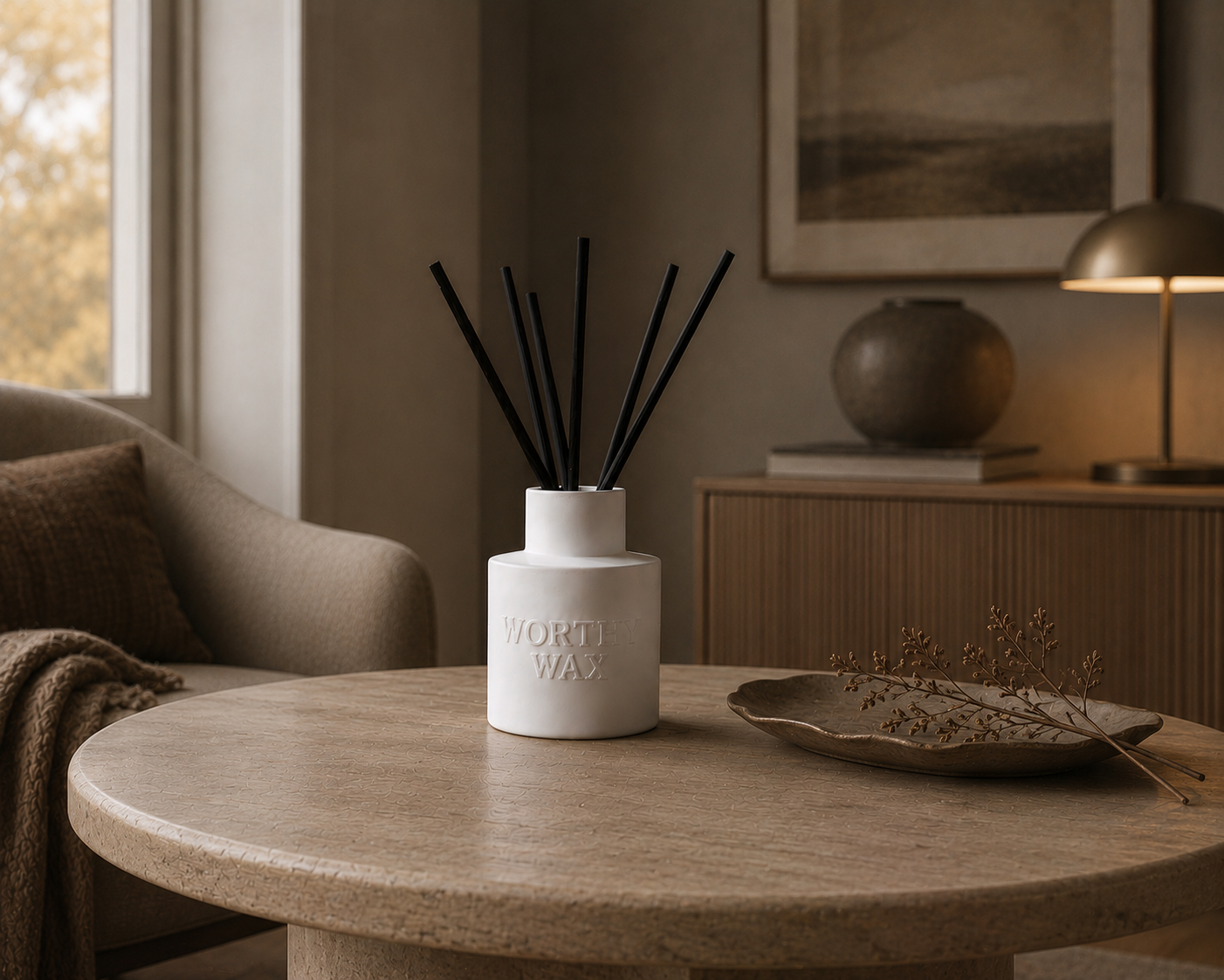 Velvet Ember reed diffuser with black reeds in a matte ceramic Worthy Wax bottle
